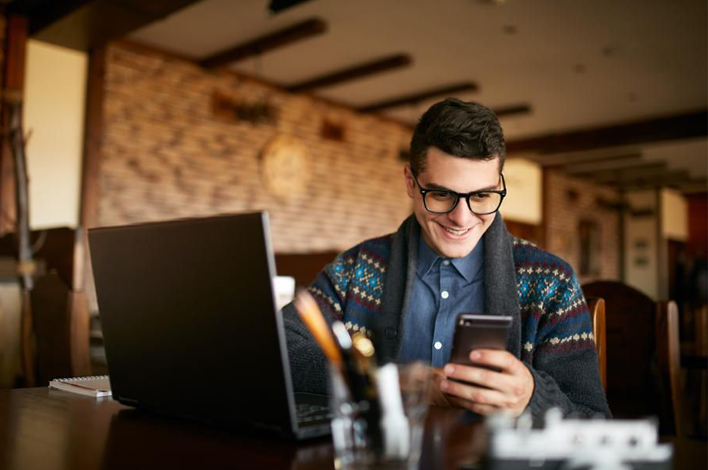 Young professional smiling at his phone