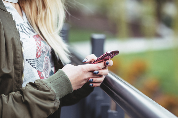 Young woman looking at her cell phone